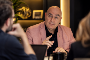 Professional hesitating to speak up in a meeting, illustrating self-doubt overriding confidence in leadership